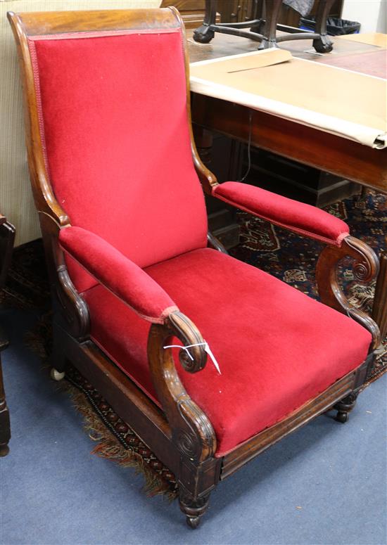 A William IV mahogany open armchair with sliding footrest